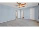 Neutral bedroom with a ceiling fan, carpet flooring, and access to various rooms at 5521 S Yakima St, Aurora, CO 80015