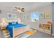 Inviting bedroom with a large window offering natural light and a comfortable, stylish decor at 5521 S Yakima St, Aurora, CO 80015
