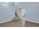 Entryway with carpeted staircase, hardwood floors, and view into kitchen area at 5521 S Yakima St, Aurora, CO 80015