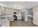 Kitchen featuring stainless steel appliances, wooden cabinets, and an adjacent dining area at 5521 S Yakima St, Aurora, CO 80015
