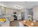 Well-lit kitchen with stainless steel appliances, wooden cabinets, and an adjacent dining area at 5521 S Yakima St, Aurora, CO 80015