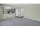 Spacious living room with an open layout that leads into a contemporary kitchen and hallway at 5521 S Yakima St, Aurora, CO 80015