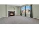 Comfortable living room featuring a cozy fireplace and large windows for natural light at 5521 S Yakima St, Aurora, CO 80015