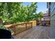 Outdoor deck area with a grill, dining table, and wood railing with partial shade at 8791 Starwood Ln, Parker, CO 80134