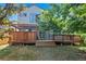 Exterior view of the house with a deck, a covered patio, and a grassy yard at 8791 Starwood Ln, Parker, CO 80134