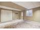 Spacious carpeted basement featuring a double-door closet and a window for natural light at 8791 Starwood Ln, Parker, CO 80134