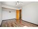 Bedroom featuring wood floors, a closet, and an open doorway at 8791 Starwood Ln, Parker, CO 80134