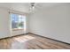 Bright bedroom with wood floors and a large window offering natural light at 8791 Starwood Ln, Parker, CO 80134