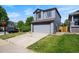 This home features a well-manicured lawn, gray siding, and an attached two-car garage at 8791 Starwood Ln, Parker, CO 80134
