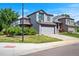The two-story home features a well-manicured lawn, gray siding, and an attached two-car garage at 8791 Starwood Ln, Parker, CO 80134