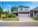 Charming two-story home boasts a well-manicured lawn, gray siding, and an attached two-car garage at 8791 Starwood Ln, Parker, CO 80134