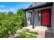 Charming front porch with a striking red door and meticulously maintained landscaping at 8791 Starwood Ln, Parker, CO 80134