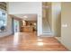 Open living room with hardwood floors leading into the kitchen and staircase to the second level at 8791 Starwood Ln, Parker, CO 80134