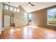 Bright and airy living room with high ceilings, beautiful hardwood floors, and large windows at 8791 Starwood Ln, Parker, CO 80134