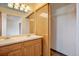 Main bathroom features dual sinks, mirror, cabinetry, and a closet for storage at 8791 Starwood Ln, Parker, CO 80134