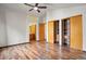 Main bedroom with wood floors, ensuite bathroom, and closet storage at 8791 Starwood Ln, Parker, CO 80134