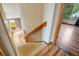 View of the carpeted staircase leading upstairs, showing natural light and wooden railing at 8791 Starwood Ln, Parker, CO 80134