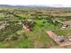 Picturesque aerial view of vast acreage with horse paddocks and residential properties in the distance at 3850 Hopi Dr, Sedalia, CO 80135