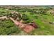 Scenic aerial view highlights a horse ranch, paddocks, and the lush landscape of a rural community at 3850 Hopi Dr, Sedalia, CO 80135
