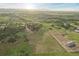 Wide aerial view of a property with an equestrian area surrounded by rolling hills at 3850 Hopi Dr, Sedalia, CO 80135