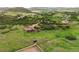 Overhead shot of a sprawling estate featuring pastures and equestrian facilities surrounded by scenic terrain at 3850 Hopi Dr, Sedalia, CO 80135