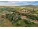 Aerial view of a home nestled in a lush, green, tree-covered landscape with hills in the distance at 3850 Hopi Dr, Sedalia, CO 80135