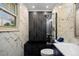 This contemporary bathroom features marble-style walls, a black soaking tub, and a glass-enclosed shower at 3850 Hopi Dr, Sedalia, CO 80135