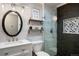 Stylish bathroom featuring a glass shower with black tiles and a vanity with a mirror at 3850 Hopi Dr, Sedalia, CO 80135