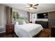 Bedroom with wood floors, ceiling fan, and windows offering views of the landscape at 3850 Hopi Dr, Sedalia, CO 80135