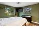 Bedroom with green walls, piano, guitar, and exterior views at 3850 Hopi Dr, Sedalia, CO 80135