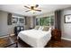 Bedroom with wood floors, ceiling fan, and large windows offering views of the outside at 3850 Hopi Dr, Sedalia, CO 80135