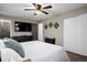 Bedroom with wood floors, ceiling fan, and large windows offering views of the landscape at 3850 Hopi Dr, Sedalia, CO 80135