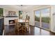 Inviting dining room featuring a fireplace, wood floors, and sliding doors to the outdoor deck at 3850 Hopi Dr, Sedalia, CO 80135