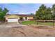 Charming ranch-style home with brick accents, an attached two-car garage, and a well-manicured front yard at 3850 Hopi Dr, Sedalia, CO 80135