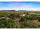 An appealing exterior view shows the home perched atop a hill, surrounded by lush greenery and a picturesque mountain backdrop at 3850 Hopi Dr, Sedalia, CO 80135