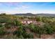Aerial view of a charming home with a deck nestled atop a hill, offering scenic mountain views and a tranquil atmosphere at 3850 Hopi Dr, Sedalia, CO 80135