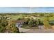 Aerial view of a home featuring a charming facade, a spacious yard, and an inviting driveway, with scenic surroundings at 3850 Hopi Dr, Sedalia, CO 80135