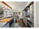 Open kitchen with granite countertops, stainless steel appliances, and wood flooring extending to dining area at 3850 Hopi Dr, Sedalia, CO 80135