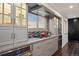 Modern kitchen featuring stainless steel appliances, gray cabinets, and tile backsplash with a view at 3850 Hopi Dr, Sedalia, CO 80135