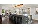 Modern kitchen with a large island, barstool seating, and contemporary lighting fixtures at 3850 Hopi Dr, Sedalia, CO 80135