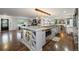 Spacious kitchen with wine rack and seating at island, featuring modern stainless steel appliances and pendant lighting at 3850 Hopi Dr, Sedalia, CO 80135