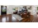 Cozy living room with hardwood floors, leather seating, a bay window, and an ornate front door at 3850 Hopi Dr, Sedalia, CO 80135