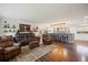 Open living space with hardwood floors, comfortable leather seating, and an expansive island with barstool seating at 3850 Hopi Dr, Sedalia, CO 80135