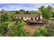 Rear exterior with deck overlooking greenery at 3850 Hopi Dr, Sedalia, CO 80135