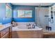 Lovely blue bathroom features a soaking tub, walk-in shower, windows, and tiled flooring at 474 Rose Finch Cir, Highlands Ranch, CO 80129