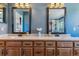 Bathroom showcasing a double sink vanity, decorative mirrors, and flowers at 474 Rose Finch Cir, Highlands Ranch, CO 80129
