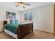 Bedroom featuring a comfy bed, ceiling fan, window view, and decorative wall art at 474 Rose Finch Cir, Highlands Ranch, CO 80129