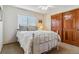 Cozy bedroom showcasing a full bed and wood closet doors at 474 Rose Finch Cir, Highlands Ranch, CO 80129