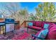 Outdoor deck features a grill, cushioned seating, and a colorful rug for a relaxing outdoor space at 474 Rose Finch Cir, Highlands Ranch, CO 80129