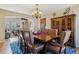 Spacious dining room with hardwood floors, a large cabinet, a beautiful chandelier, and seating for eight at 474 Rose Finch Cir, Highlands Ranch, CO 80129